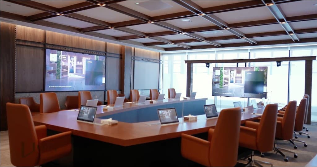 Modern boardroom with conference table, displays and collaboration technology